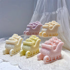 Sleigh candles filled with sculpted Christmas presents in pastel colors