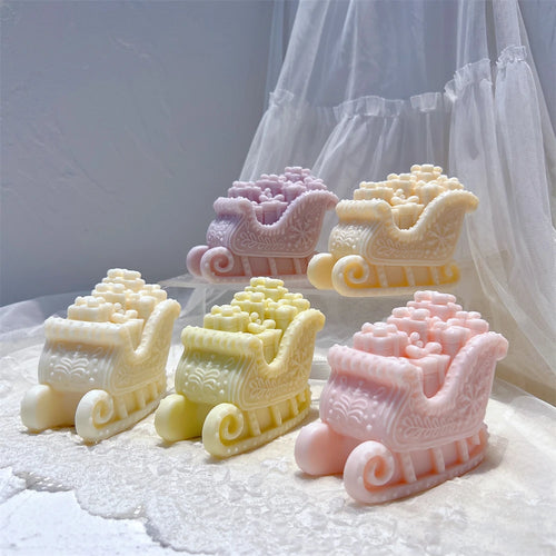 Sleigh candles filled with sculpted Christmas presents in pastel colors