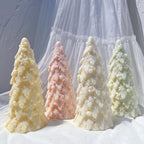 Four snowy layered tree castings with rounded branch tips