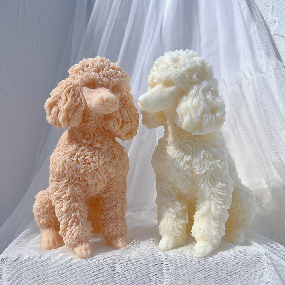 Two sitting poodle castings with rounded muzzles