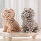 Pair of fluffy seated dog sculptures with small ears and front paws