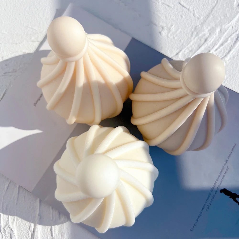 Overhead view of three spiral droplet candle castings