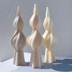 Three double-bulb twisted spindle candle castings