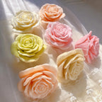 Open rose candle castings in cream, peach, pink and green