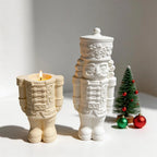 Open nutcracker vessel with lower uniform and boots beside a complete lidded figure