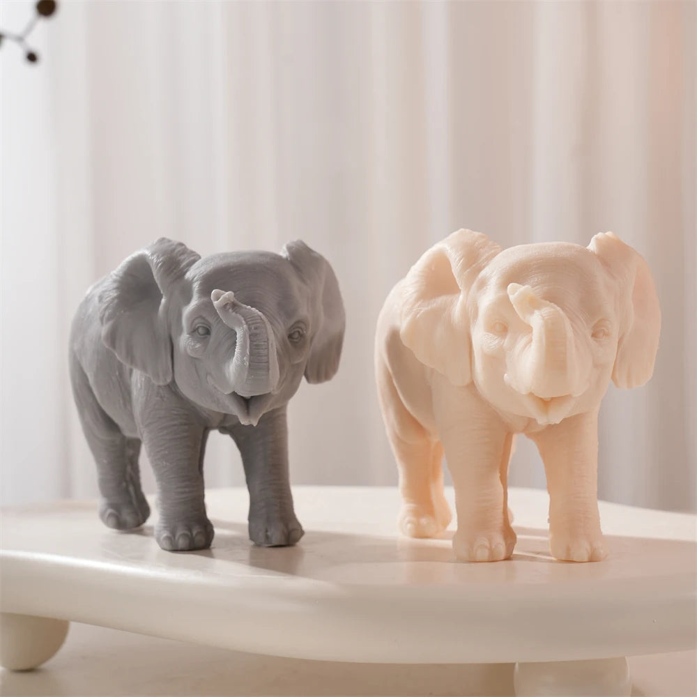 Front view of gray and peach elephants with broad ears