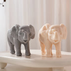 Front view of gray and peach elephants with broad ears