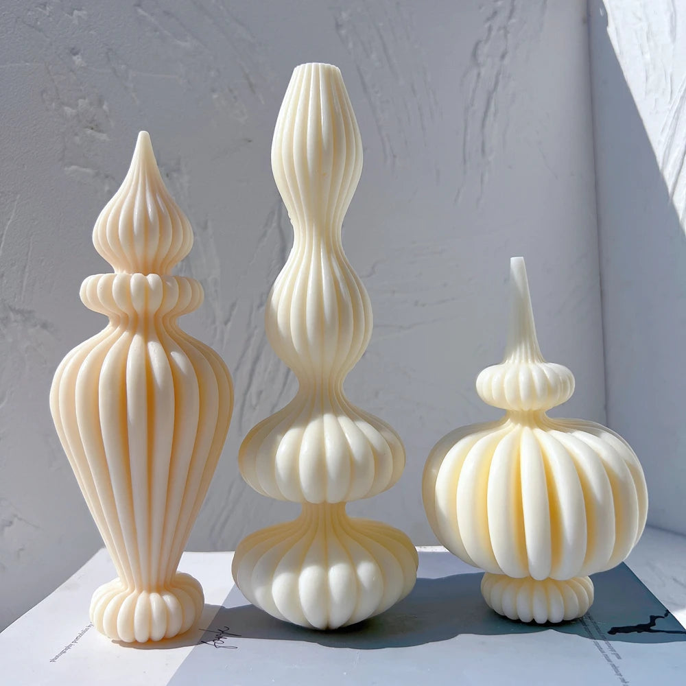 Three sculptural ribbed pillar candle shapes