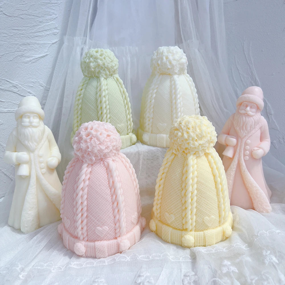 Tall cable-knit hat castings arranged among winter figurines