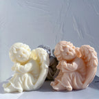 Seated cherub figurines with tilted heads and folded arms