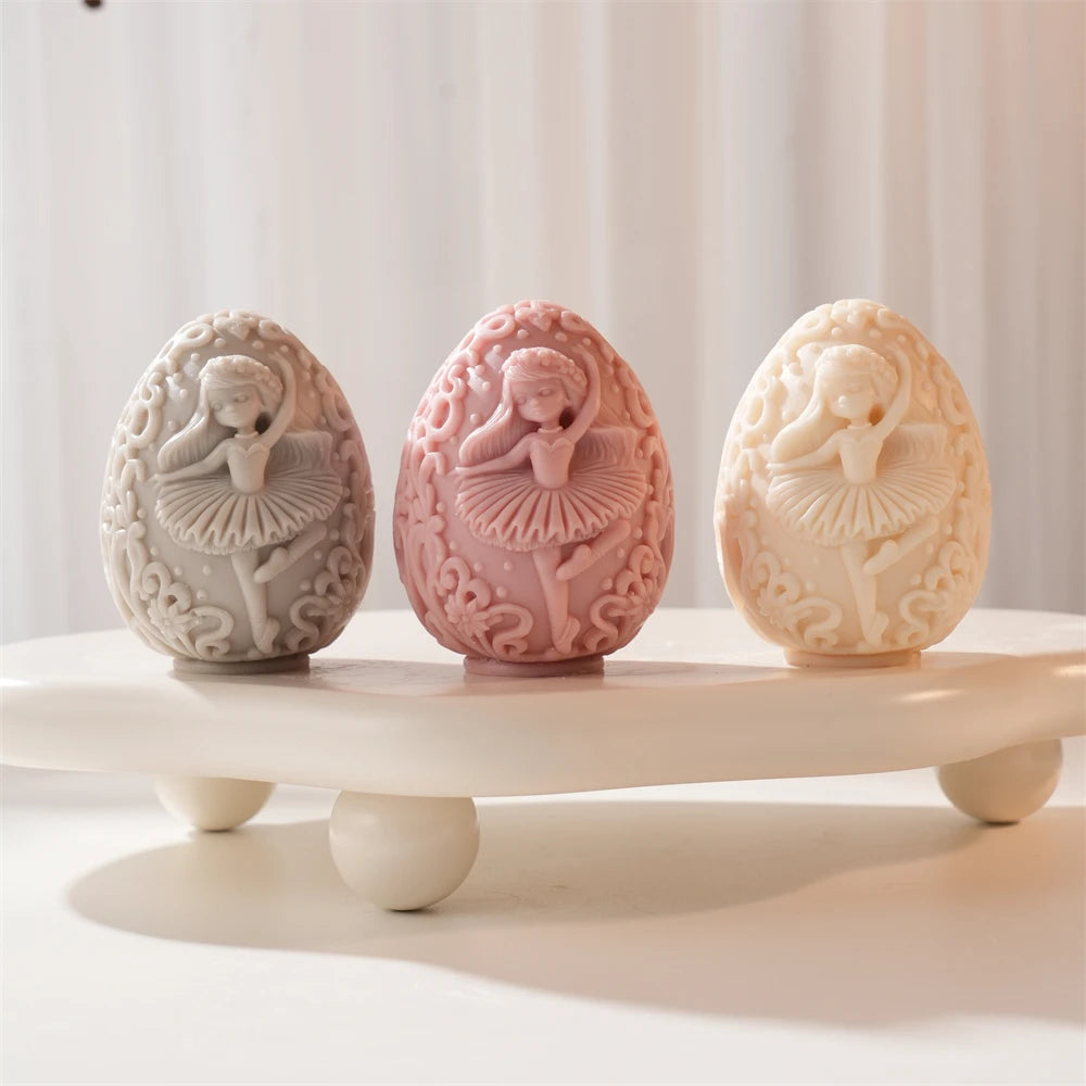 Three egg candles with ballerina and scrollwork relief