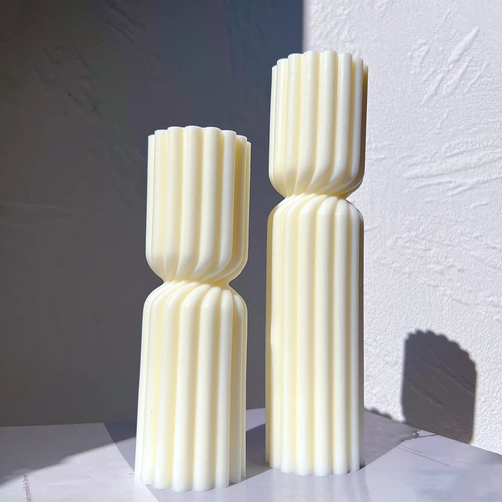Small and large versions of a double-section fluted pillar candle