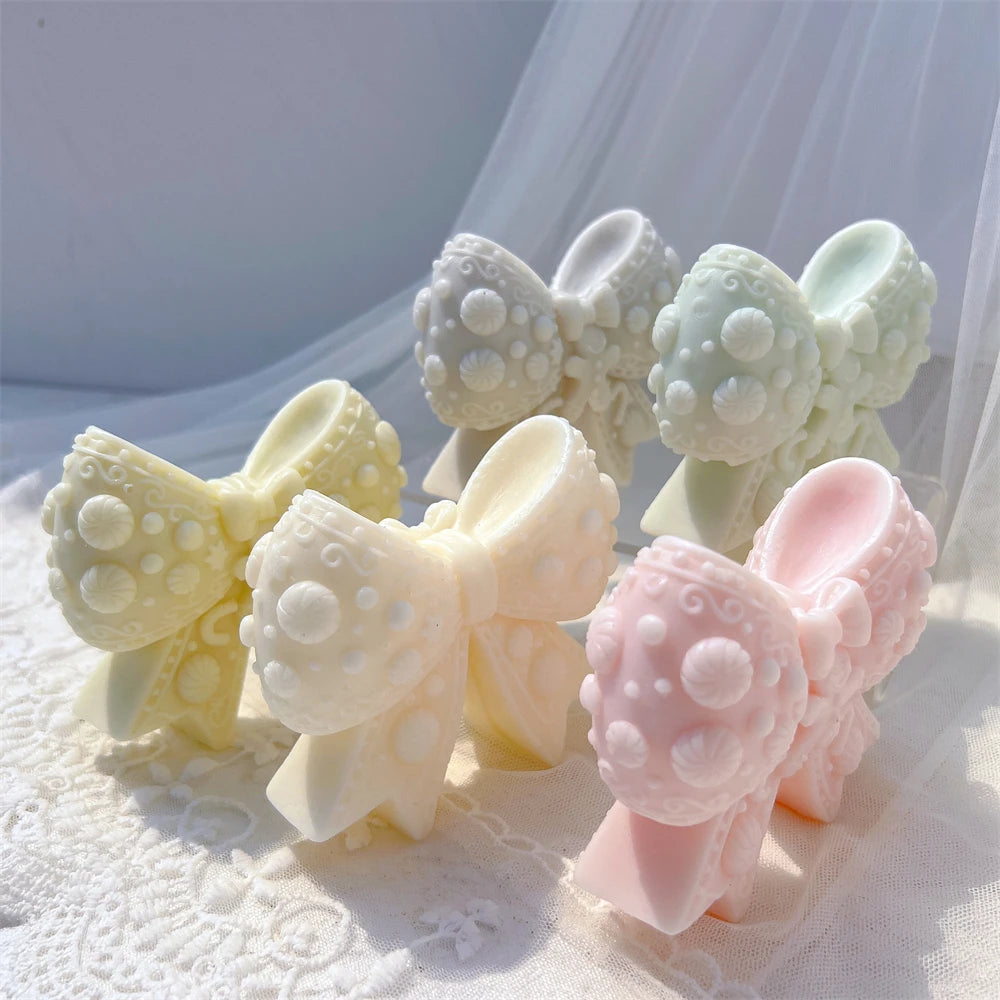 Several decorated bow castings with projecting ribbon tails