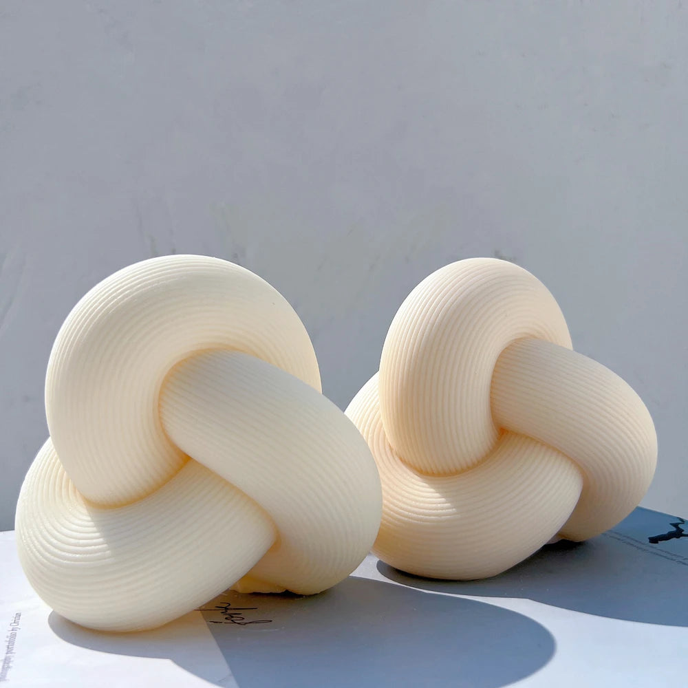 Curved knot candle castings with fine surface grooves
