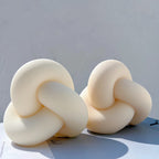 Curved knot candle castings with fine surface grooves
