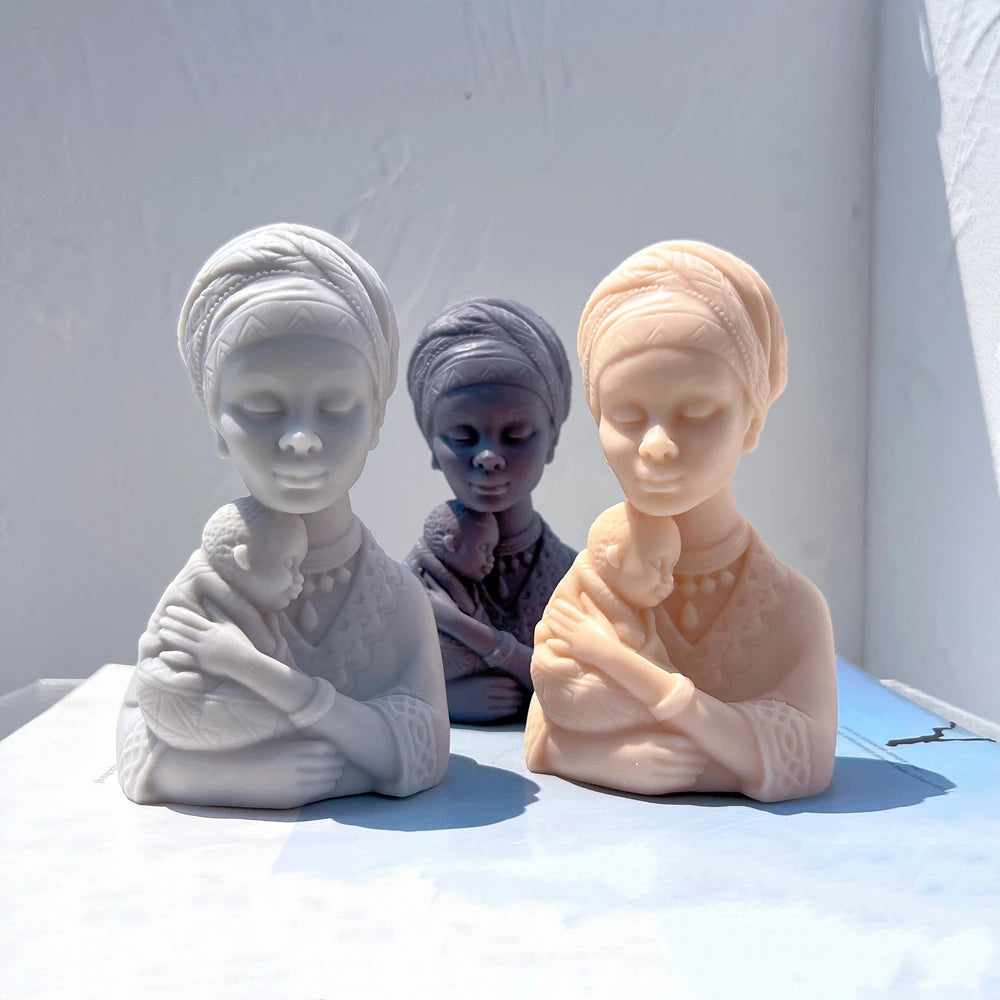 Mother and baby bust castings with wrapped head coverings
