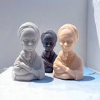 Mother and baby bust castings with wrapped head coverings