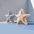 Peach textured star candle in front of gray and cream star samples
