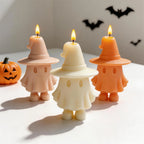 Peach cream and orange ghost candles with broad witch hats