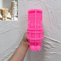 Pink silicone nutcracker soldier mold showing reliefs of face coat and boots