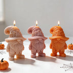 Three Halloween gnome candles with long beards and buckled boots