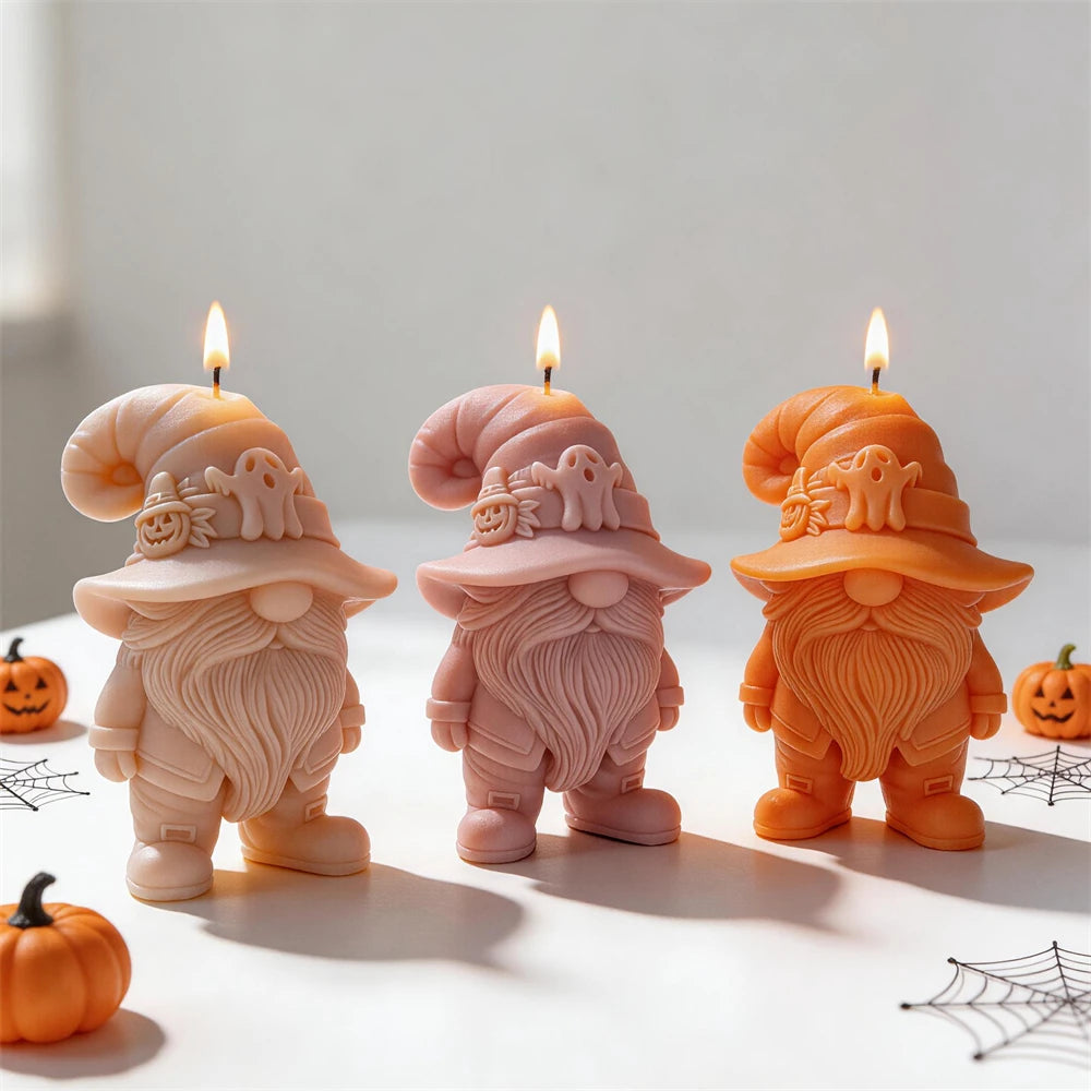 Three Halloween gnome candles with long beards and buckled boots