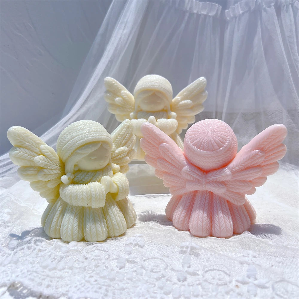 Rear of pink angel beside green and cream front-facing figures