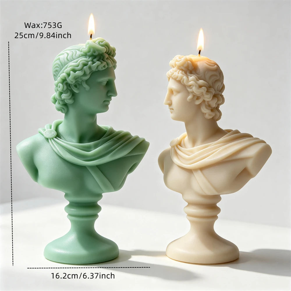 Green and cream classical Apollo bust candle castings viewed from the front