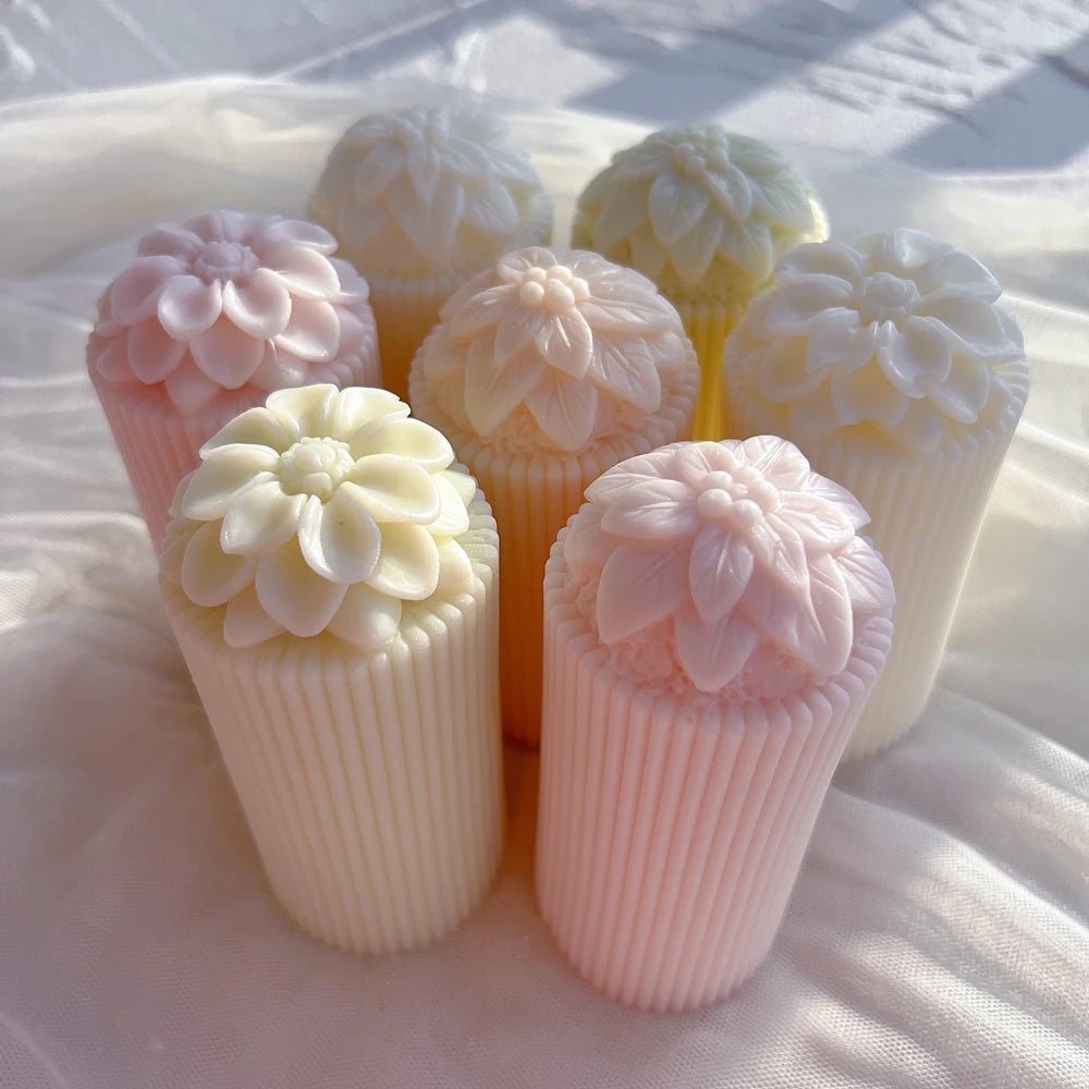 Grouped pastel flower-topped ribbed candles