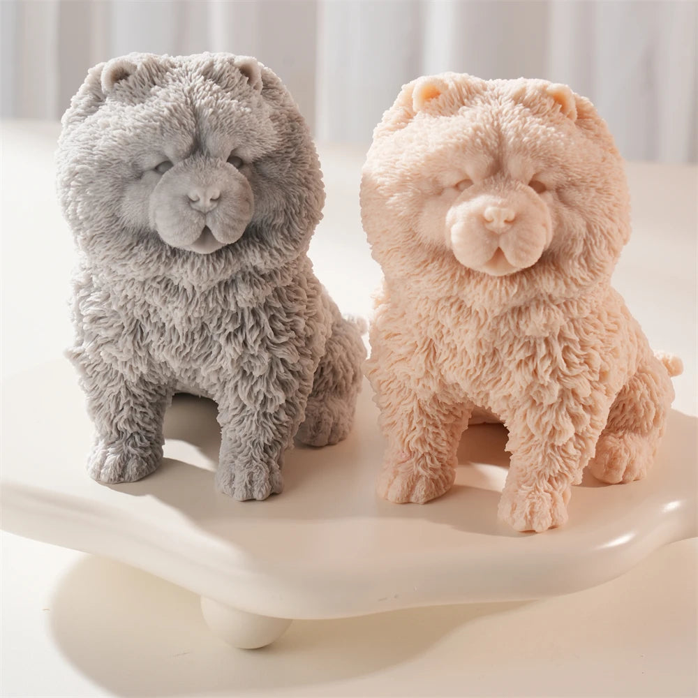 Gray and peach seated fluffy Chow Chow dog candle figures viewed at an angle