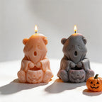 Ghost bear candle samples beside decorative Halloween pumpkins