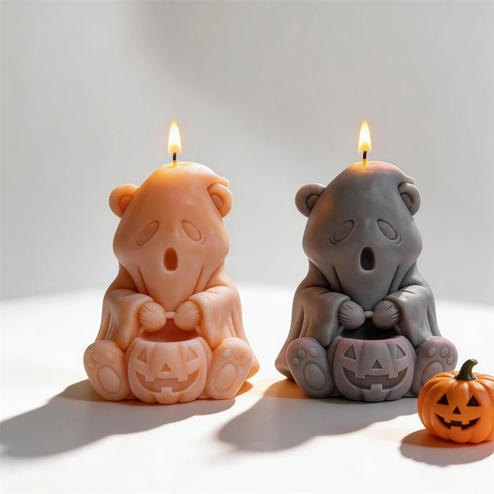 Ghost bear candle samples beside decorative Halloween pumpkins