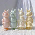 Bonneted rabbit figures showing their tied neck ribbons