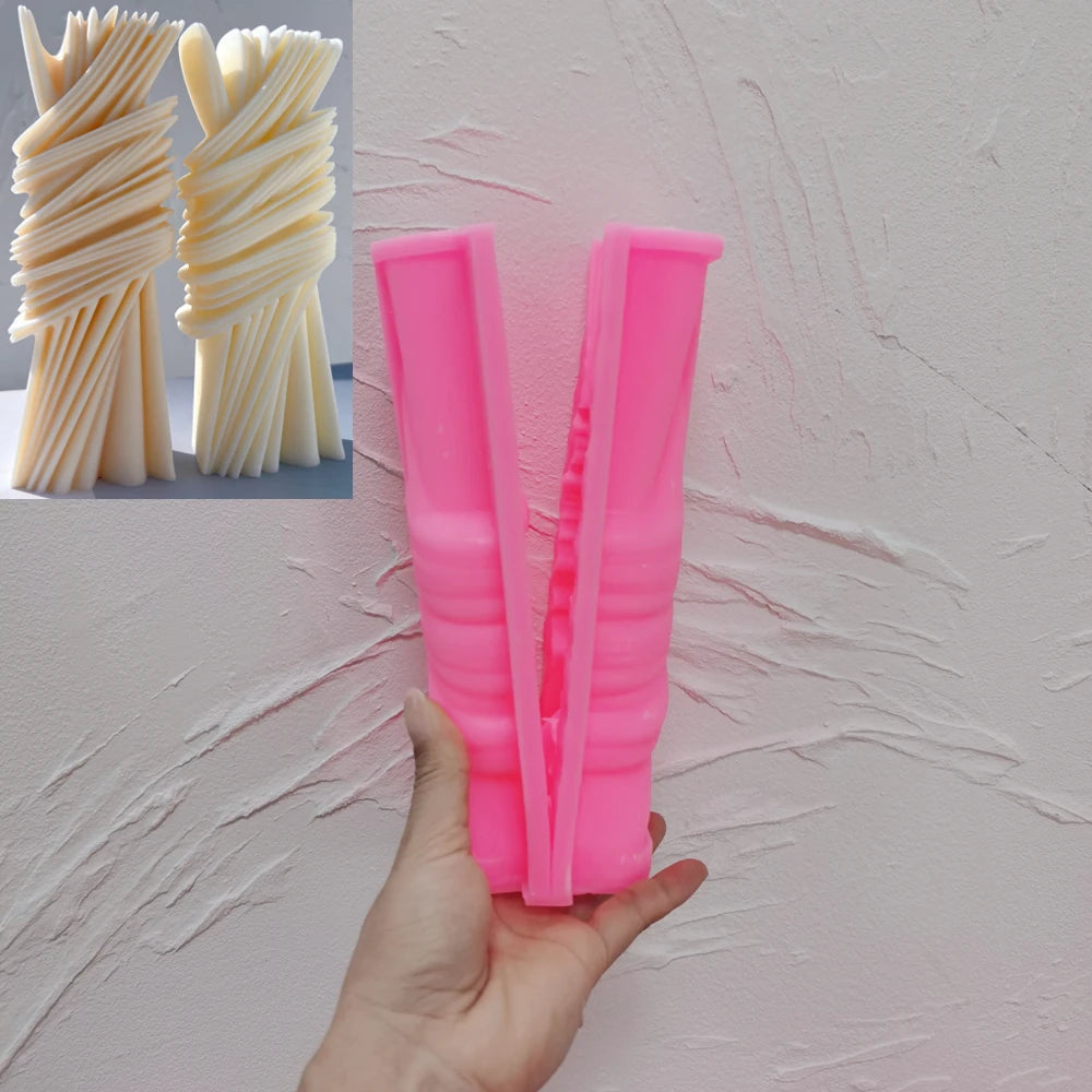 Pink silicone wrapped ribbon pillar mold held open in a hand