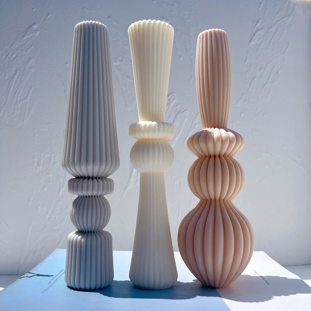 Three tall ribbed baluster candle designs