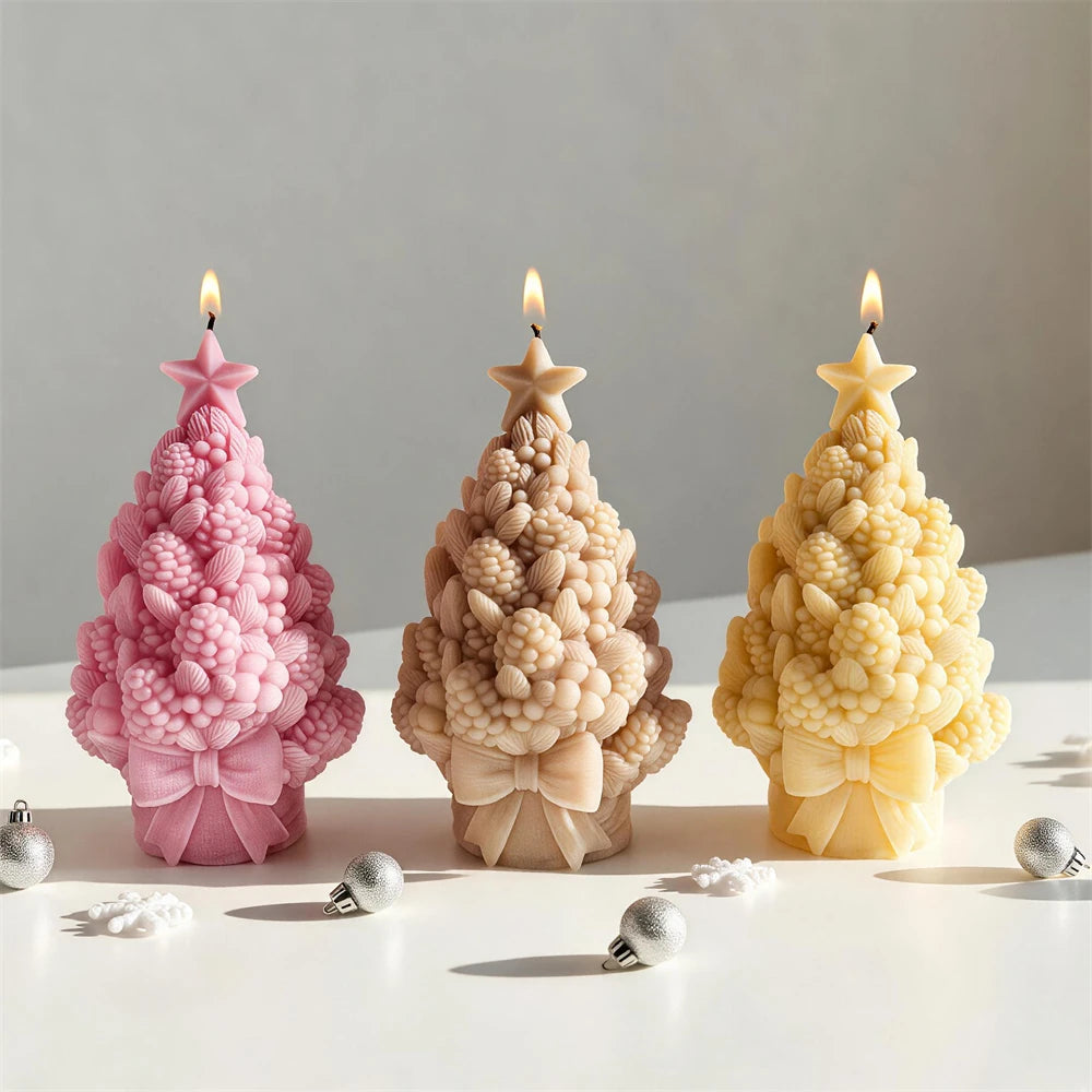 Pink tan and yellow star-topped pinecone tree candles with bow bases