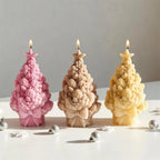 Pink tan and yellow star-topped pinecone tree candles with bow bases