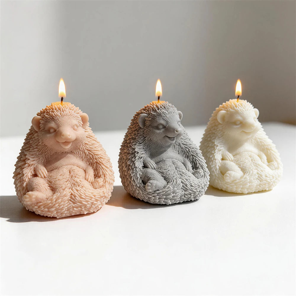 Tan gray and white hedgehog sculptures with small paws and spines