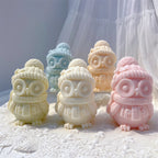 Pastel owl candle samples wearing pom-pom winter hats and scarves