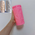 Pink silicone fern pillar mold held beside example castings