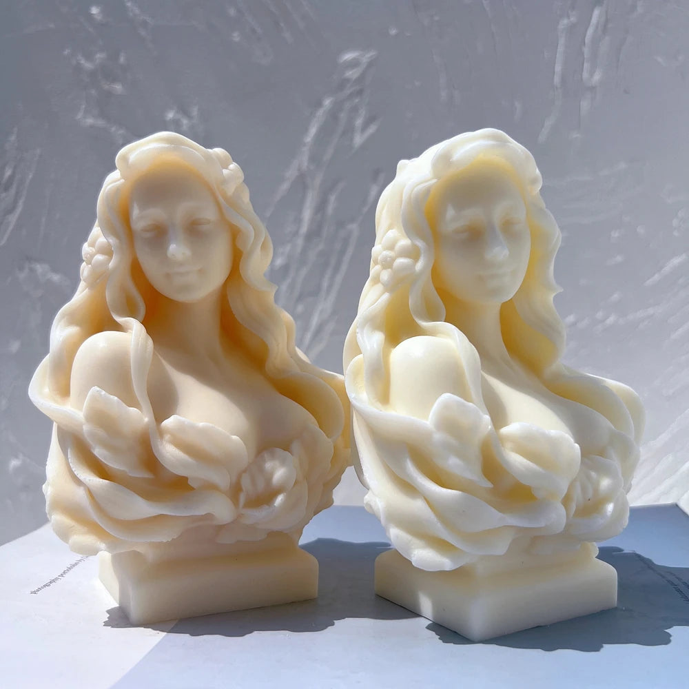 Two front-facing female busts on stepped pedestals