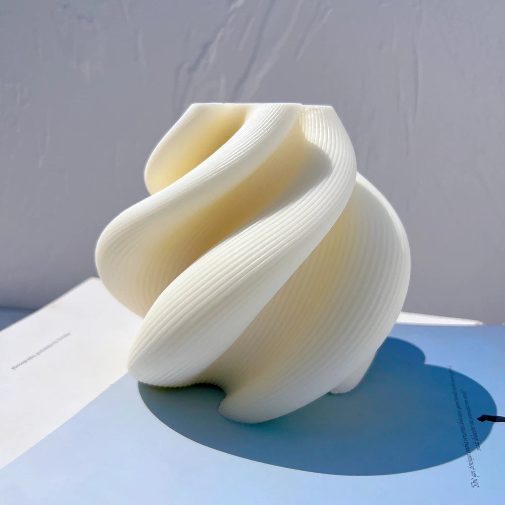 Rounded spiral candle form with sweeping folds and deep channels