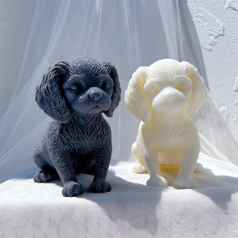 Black and cream seated puppy castings with floppy ears
