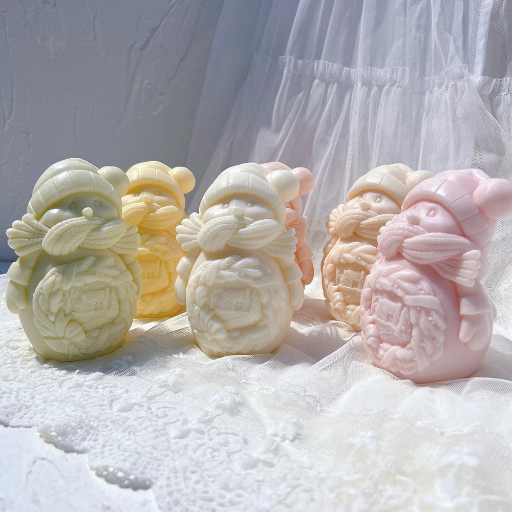 Snowman candles cuddling smaller snowmen in pastel colors