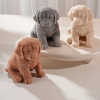 Close three-quarter views of retriever puppy figurines with front paws and drooping ears