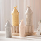 Group of crescent-finial candle castings with patterned cylinders and pointed roofs