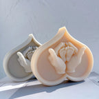 Heart relief casting with a pair of hands holding baby feet