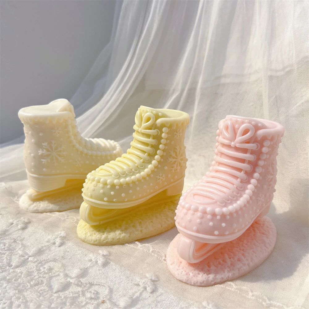 Three winter skate boot candles with raised lace details and snowflake motifs