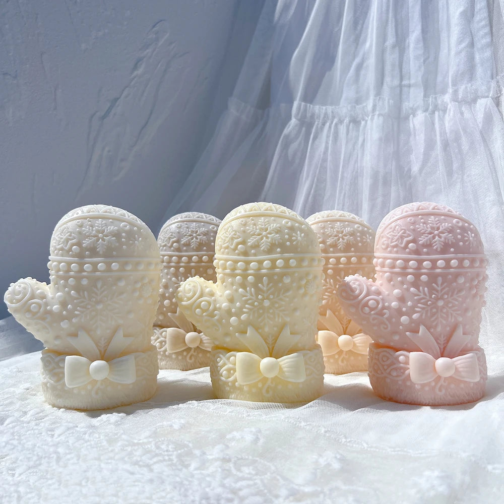 Three mitten castings with thumbs and bow-trimmed cuffs