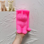 Pink Shiba Inu silicone candle mold held in one hand